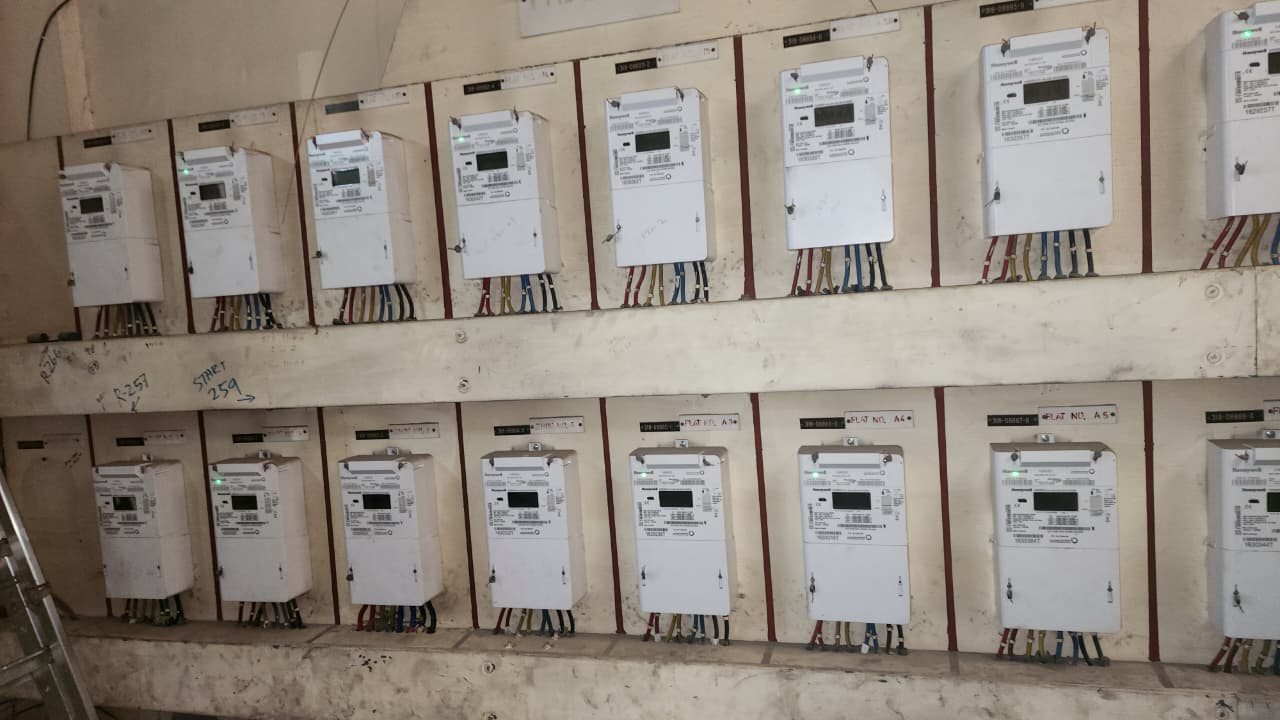 Bank of 16 Honeywell DEWA electricity meters in a Dubai residential building